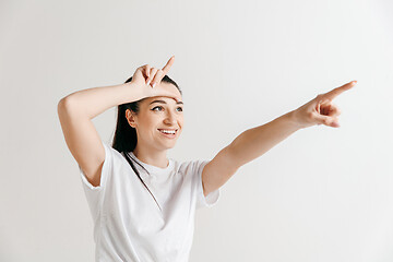 Image showing Losers go home. Portrait of woman showing loser sign over forehead