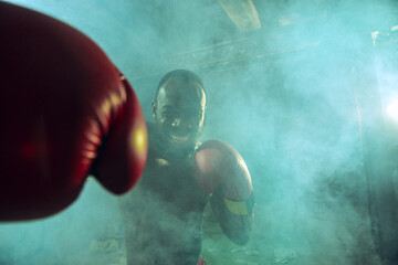 Image showing Hand of boxer over black background. Strength, attack and motion concept