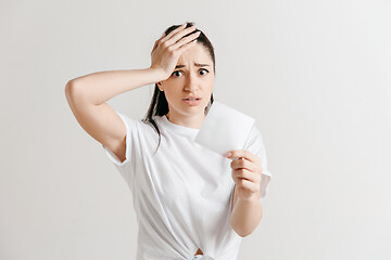 Image showing Young woman with a sad expression lost a bet