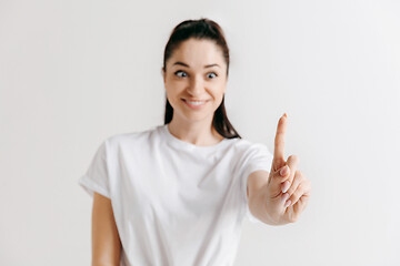 Image showing Woman\'s hand with finger on gray background