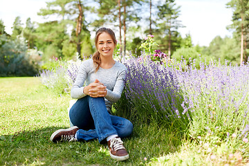 Image showing young woman and lavender flowers at summer garden