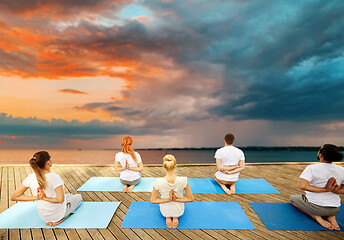 Image showing group of people making yoga exercises outdoors