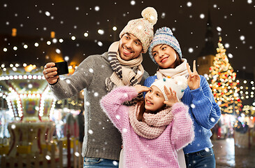 Image showing happy family taking selfie at christmas market