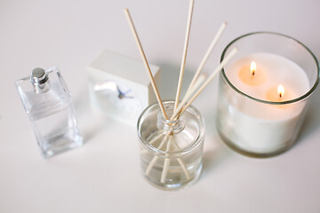 Image showing aroma reed diffuser, burning candle and perfume