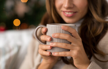 Image showing close up of woman with cup of coffee on christmas