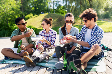 Image showing happy friends having picnic at summer park