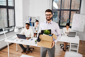 Image showing happy male office worker with personal stuff