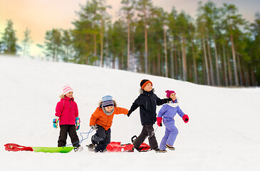 Image showing happy little kids with sleds in winter