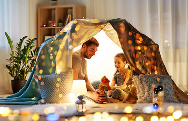 Image showing happy family playing with toy in kids tent at home