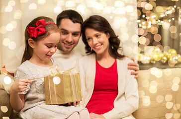 Image showing happy family with christmas present at home