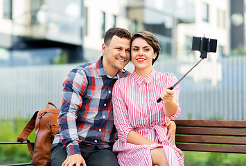 Image showing family couple with stroller taking selfie in city