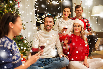 Image showing friends celebrating christmas and drinking wine