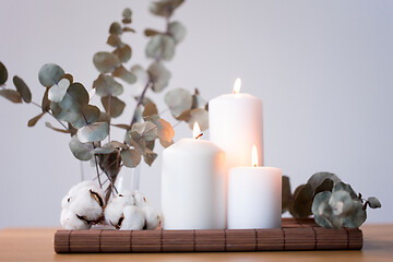 Image showing candles and branches of eucalyptus on table