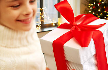 Image showing happy beautiful girl with christmas gift at home