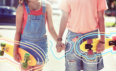 Image showing close up of young couple with skateboards in city