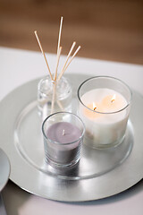 Image showing aroma reed diffuser an candles burning on tray