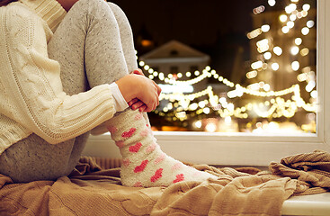 Image showing close up of girl sitting at window on christmas