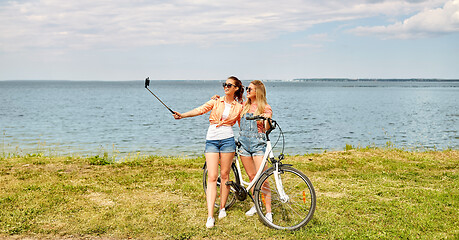 Image showing teenage girls with bicycle taking selfie in summer