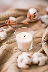 Image showing burning candle and cotton flower on blanket