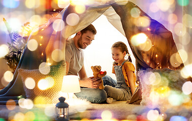 Image showing happy family playing with toy in kids tent at home