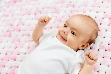 Image showing sweet baby girl lying on knitted plush blanket