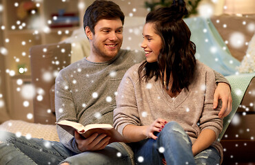 Image showing happy couple reading book at home