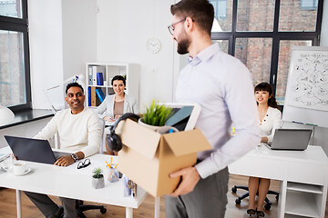 Image showing happy male office worker with personal stuff