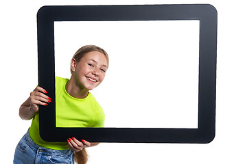 Image showing Teen girl peeking through digital tablet frame