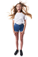 Image showing Shocked teen standing over white background shouting