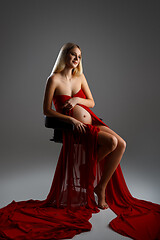 Image showing Pregnant girl in red dress