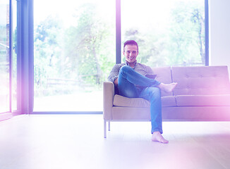 Image showing man on sofa using tablet computer