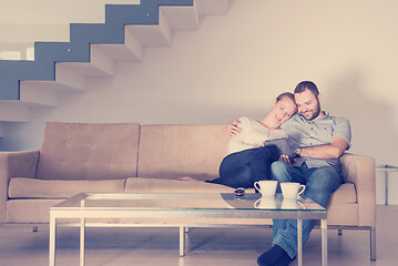 Image showing romantic couple relaxing at  home with tablet computers