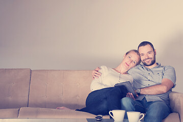 Image showing romantic couple relaxing at  home with tablet computers