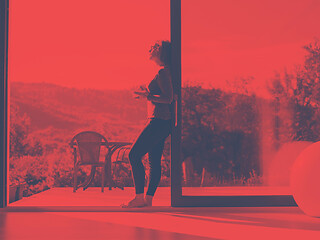 Image showing woman eating breakfast in front of her luxury home villa