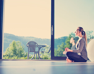 Image showing young woman doing morning yoga exercises