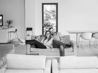 Image showing Young couple on the sofa watching television