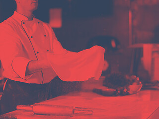 Image showing chef throwing up pizza dough