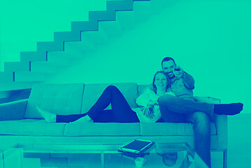 Image showing romantic couple on the sofa watching television