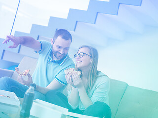 Image showing couple eating pizza in their luxury home villa