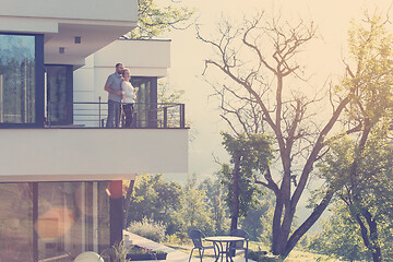 Image showing couple enjoying morning coffee on balcony