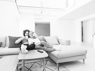 Image showing Young couple on the sofa watching television