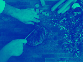 Image showing closeup of Chef hands preparing beef steak