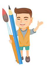 Image showing Smiling boy holding big pencil and paintbrush.