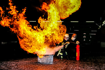 Image showing Firefighters training for fire fighting.