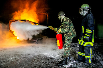 Image showing Firefighters training for fire fighting.