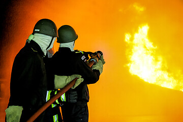 Image showing Firefighters training for fire fighting.