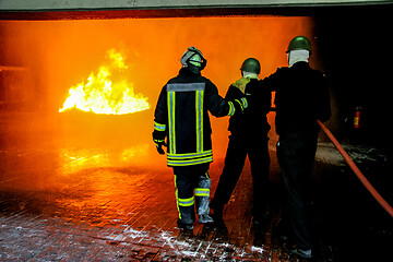 Image showing Firefighters training for fire fighting.