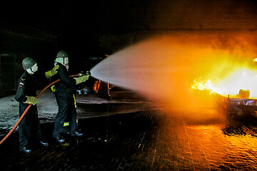 Image showing Firefighters training for fire fighting.