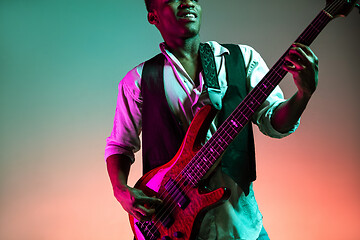 Image showing African American jazz musician playing bass guitar.