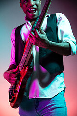 Image showing African American jazz musician playing bass guitar.